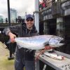 An amazingly large salmon shown off back on land