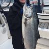 This salmon is half the size of the person who caught it